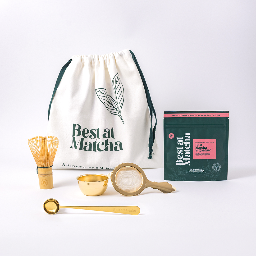 Matcha tea set with a drawstring bag, packaging, and utensils on a white background