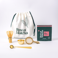 Matcha tea set with a drawstring bag, packaging, and utensils on a white background