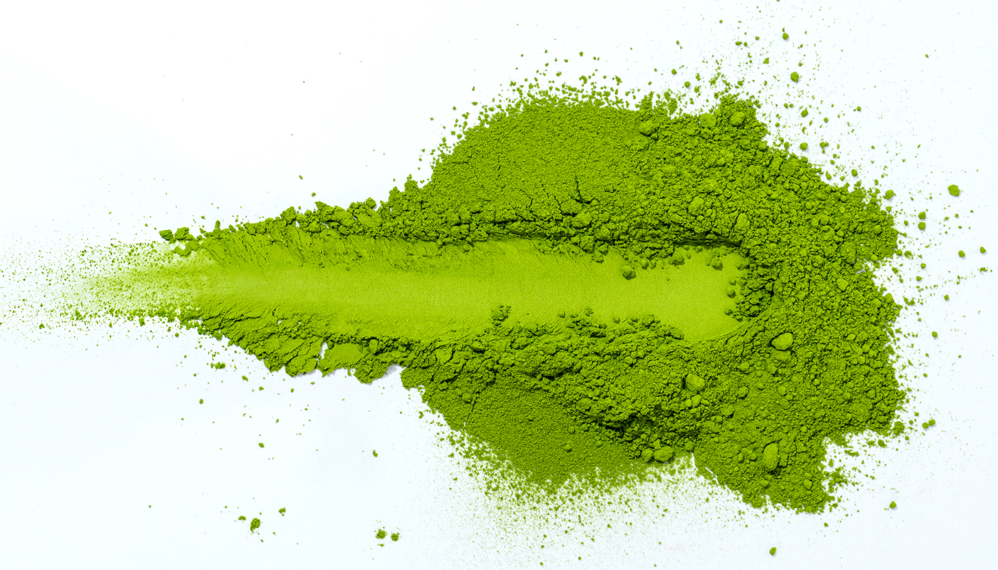 Green matcha powder on a white background