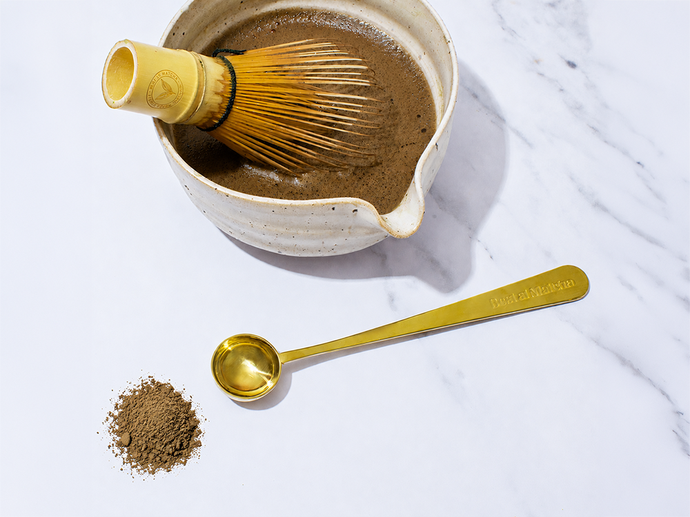 Best at Matcha hojicha powder in ceramic bowl with bamboo chasen and gold perfect scoop on marble surface