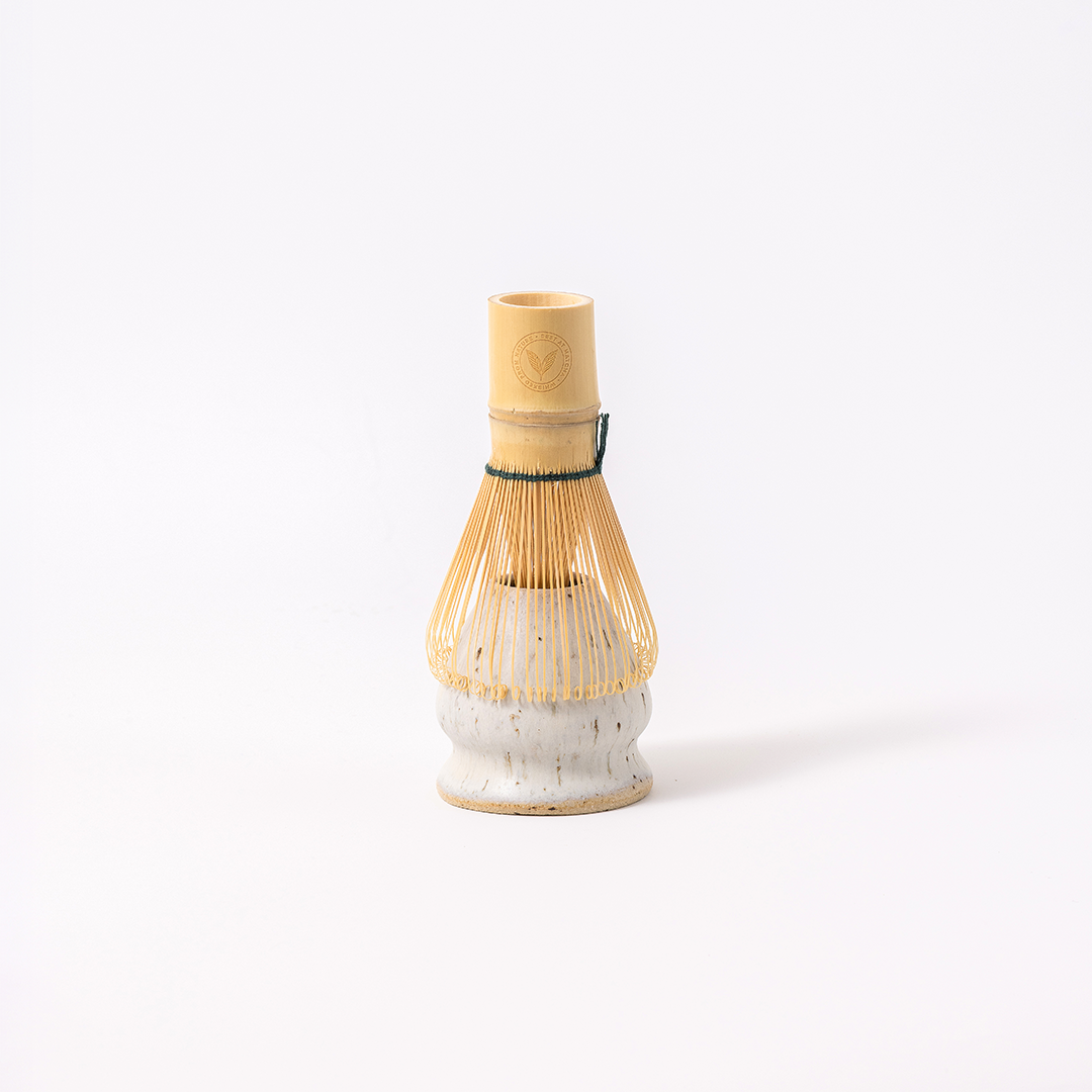 Best at Matcha bamboo chasen resting on Yuki ceramic kusenaoshi whisk stand — traditional matcha whisk and stand set