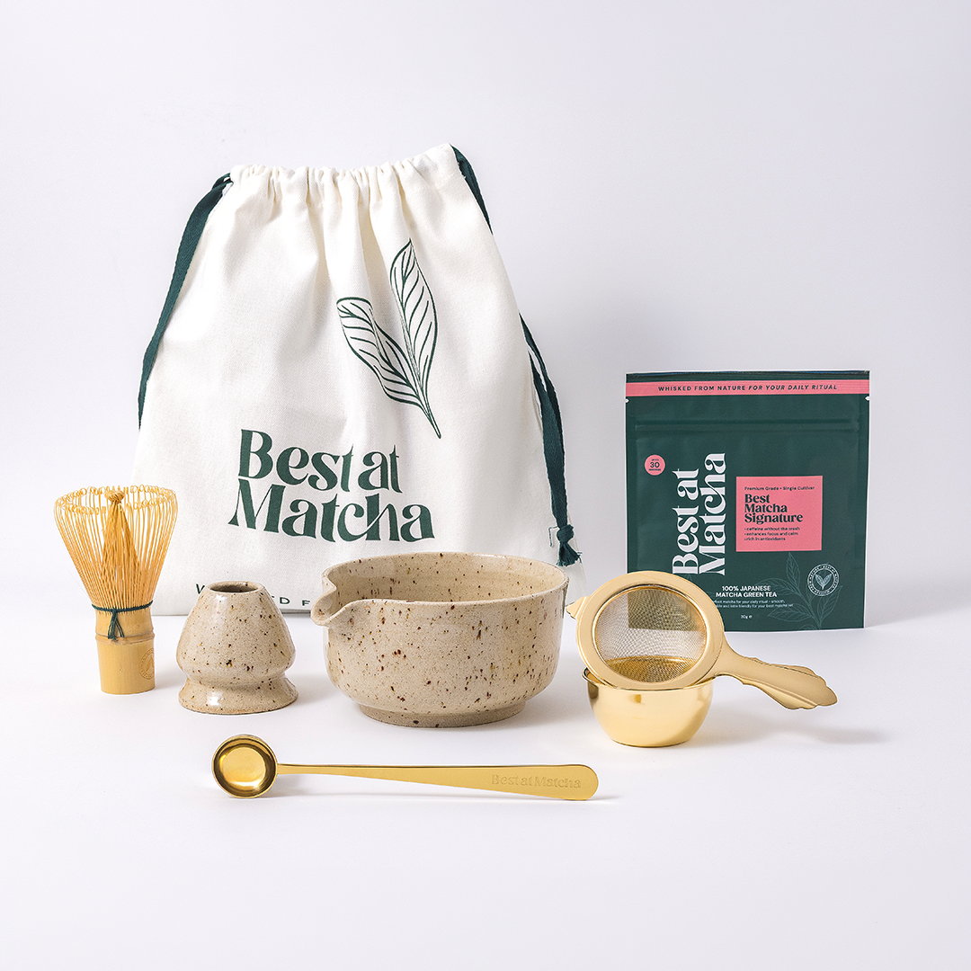 Matcha preparation set with a drawstring bag, bowl, whisk, scoop, and package on a white background